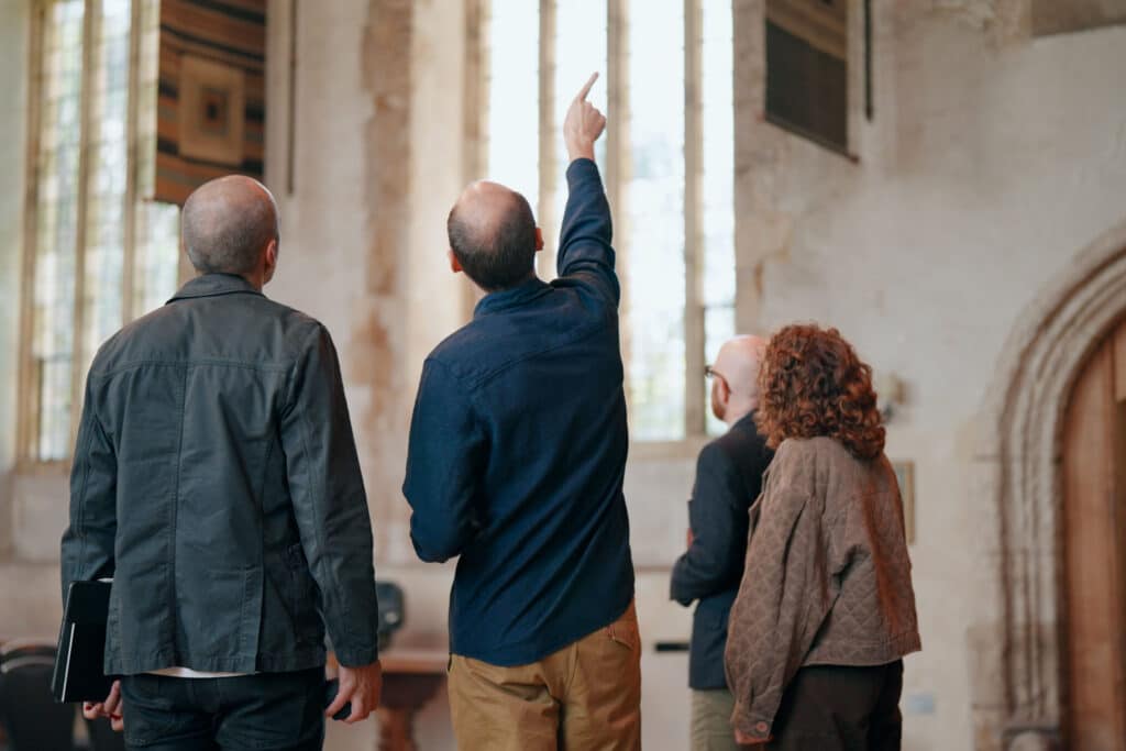 Sibley Grove team surveying a historic building interior space
