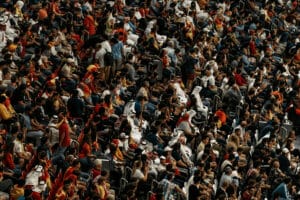 Mass of seated people - exploiting labour