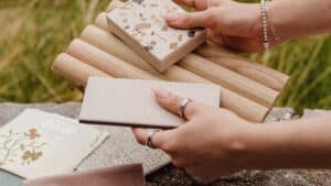 Hands holding colour and material samples