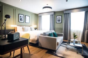 Hotel bedroom with bed, sofa and desk