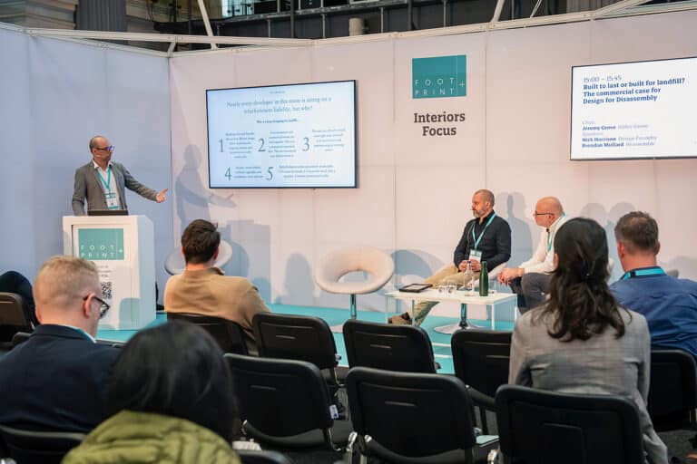 Jeremy Grove opening the "Built to Last or Built for Landfill" panel on Design for Disassembly at Footprint+ 2026, Old Billingsgate Market.